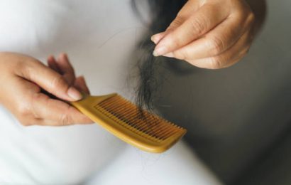 Hair fall problem. Asian woman with comb and hair problem. Hair loss from comb. Hair care and beauty concepts.