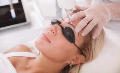 Close up of a mature woman getting her tattooed eyebrows removed with laser. Dermatologist removing eyebrow tattoo of a female patient